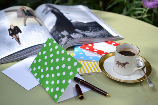 Colourful notecards on a table with coffee cup