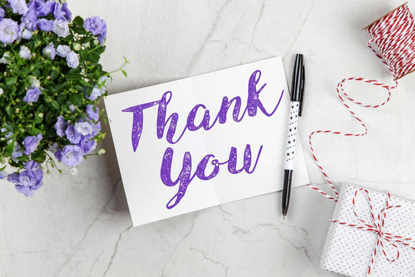 a thank you note card with a free style script font and printed in purple