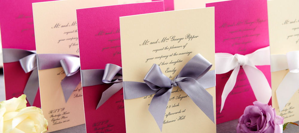 luxury wedding invitations showing cream and pink card with ribbons