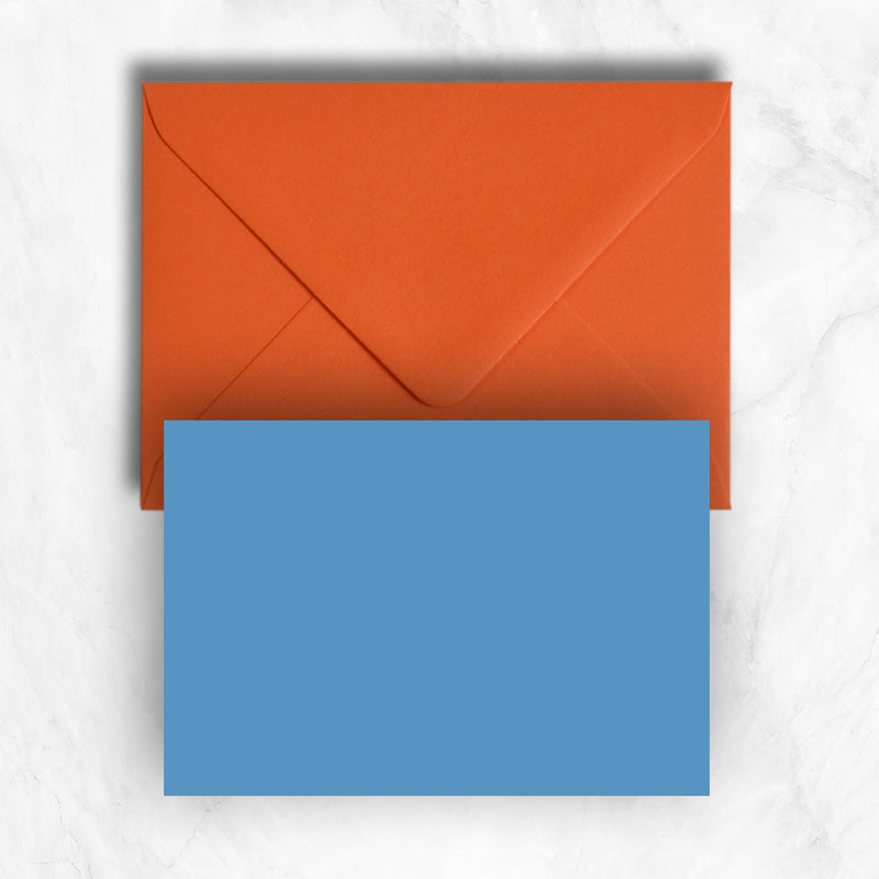 Plain lightly textured new blue a6 cards teamed with orange envelopes