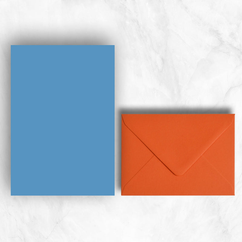 Plain lightly textured blue a5 sheets teamed with warm orange envelopes