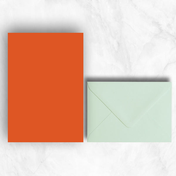 Plain lightly textured orange a5 sheets teamed with powder green envelopes