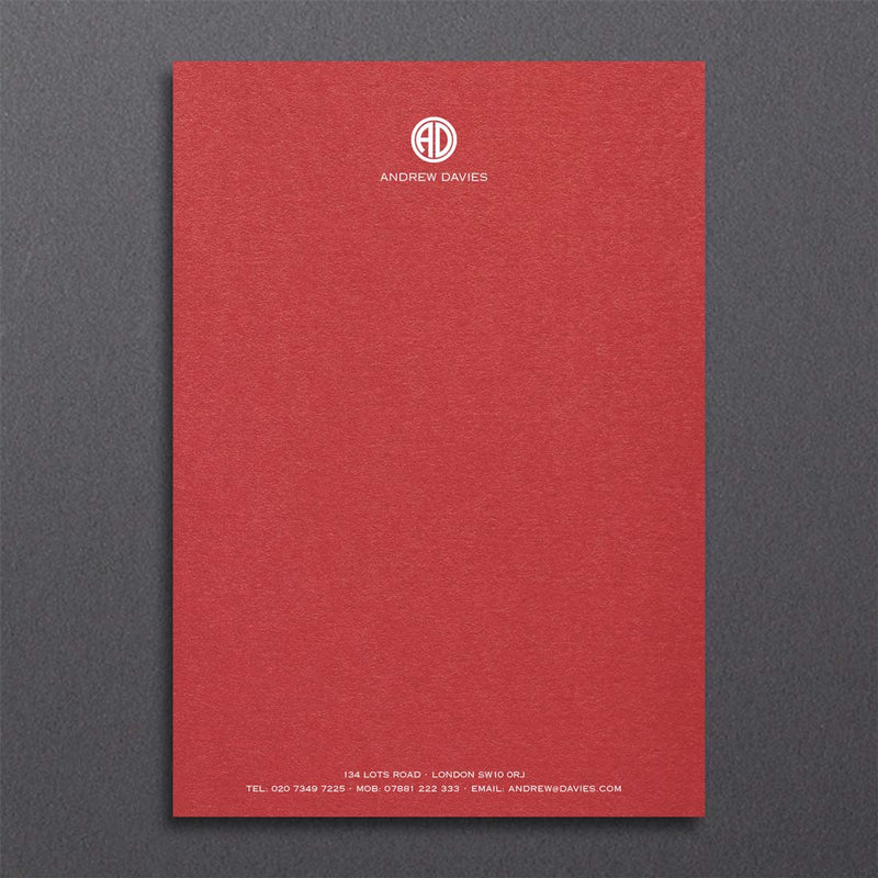 Bronte writing paper displays a contemporary monogram at the head and details at the foot, printed in white ink onto a bright red sheet