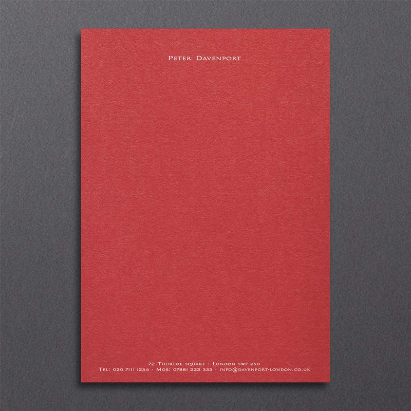 An elegant writing paper design printed in white ink onto a bright red sheet