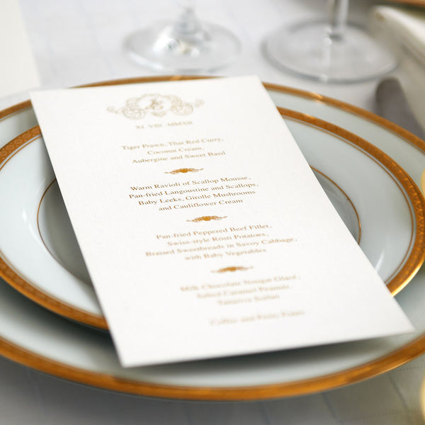 The Cologne wedding menus use gold foiled text with an elaborate monogram frames and course separators