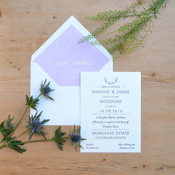 The Glenkeith letterpressed wedding invitation is shown with a lilac tissue paper lined envelope