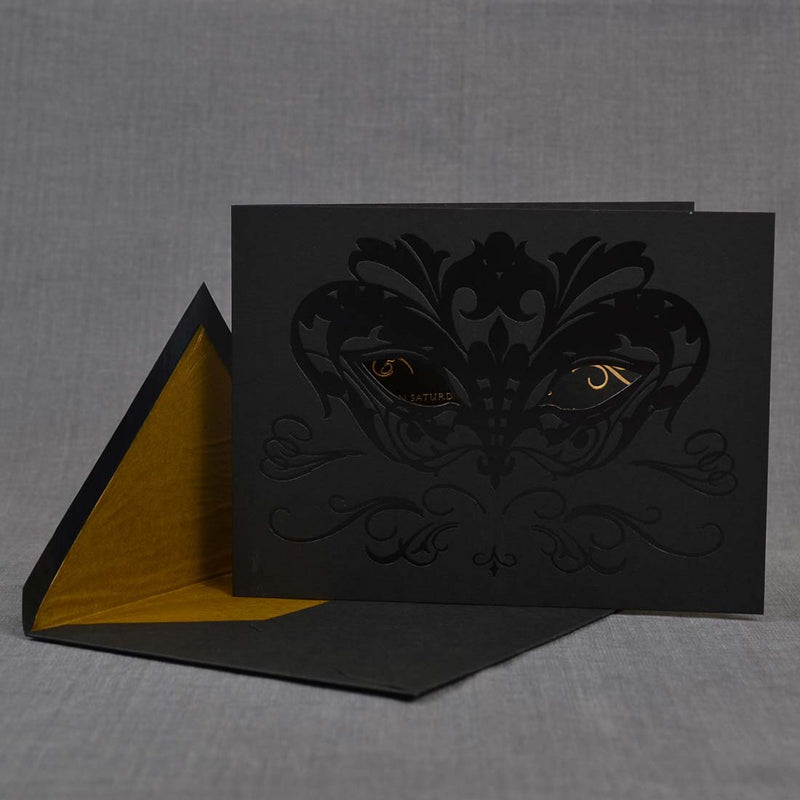 The clear foiling define the mask on the front cover of the Masquerade Ball party invitations