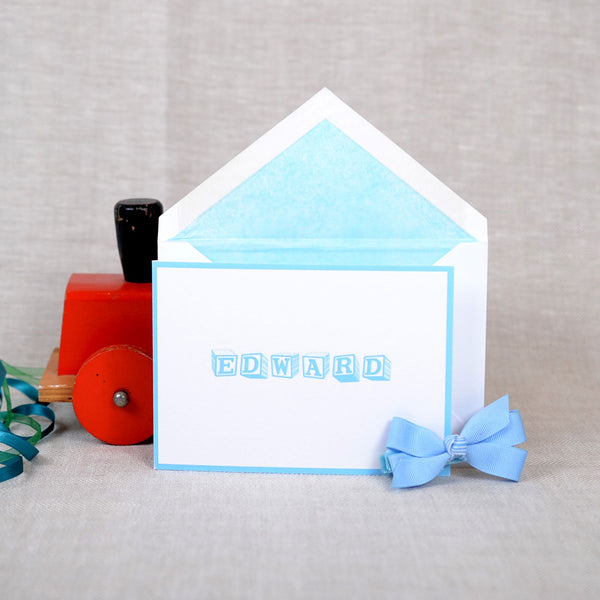 The folded Ottershaw birth announcement cards and envelope with baby blue tissue paper lining 