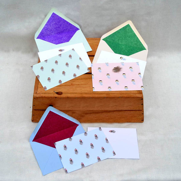 The feather notecards pack shows 3 designs of feather patterns, and each card has a single feather motif on the reverse.  