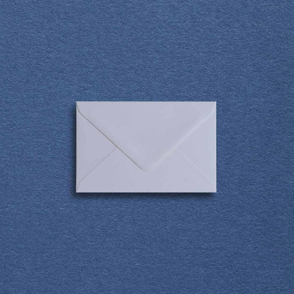 Off-white mini envelopes with a softly textured surface and diamond flaps