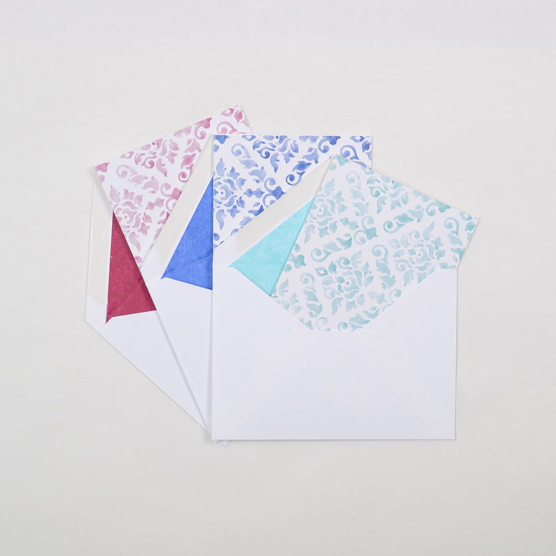 the pastel shades of damask pattern greeting card shown in their white envelopes which are lined with matching tissue paper