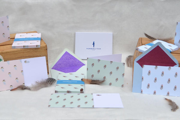 A range of feather pattern greeting cards by Nora Percy
