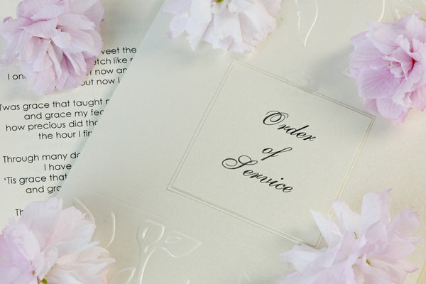 The cover of a wedding order of service with flowers