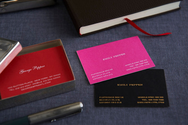 Gold and White embossed business cards on different colour cards