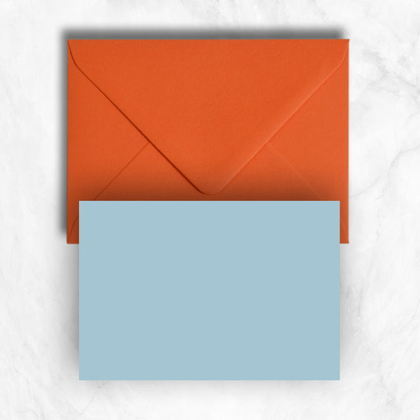 Plain lightly textured azure blue a6 cards teamed with orange envelopes