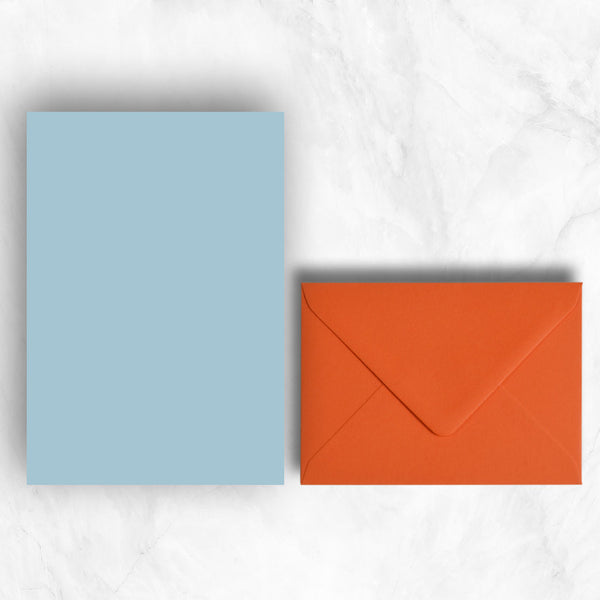 Plain lightly textured azure blue a5 writing sheets teamed with warm orange envelopes