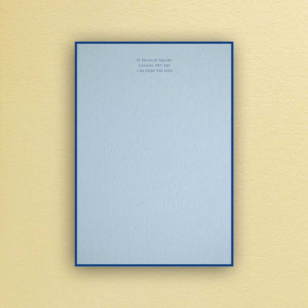 The Bond writing paper shows your personalised text printed in dark blue onto a light blue sheet with a matching border.
