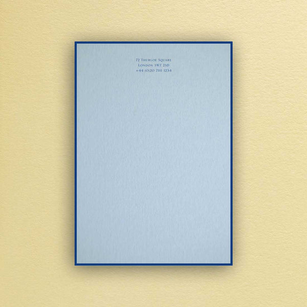 The Bond writing paper shows your personalised text printed in dark blue onto a light blue sheet with a matching border.