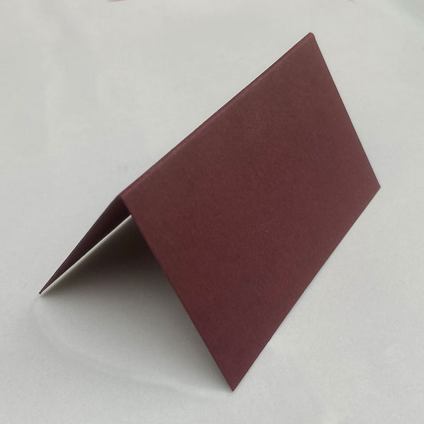 Made from a deep maroon burgundy, these folded place cards are sold in packs of 20