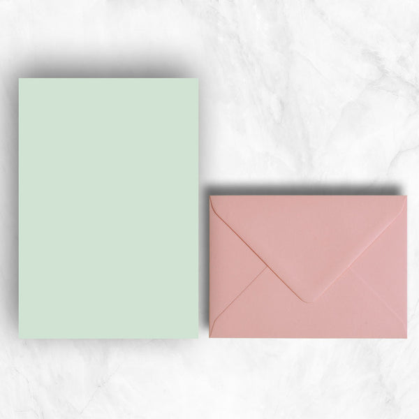 Plain lightly textured powder green a5 sheets teamed with candy pink envelopes