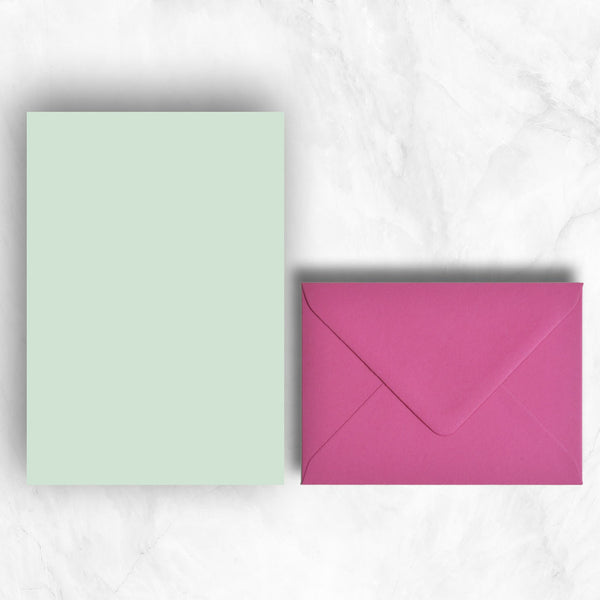 Plain lightly textured powder green a5 sheets teamed with hot pink envelopes