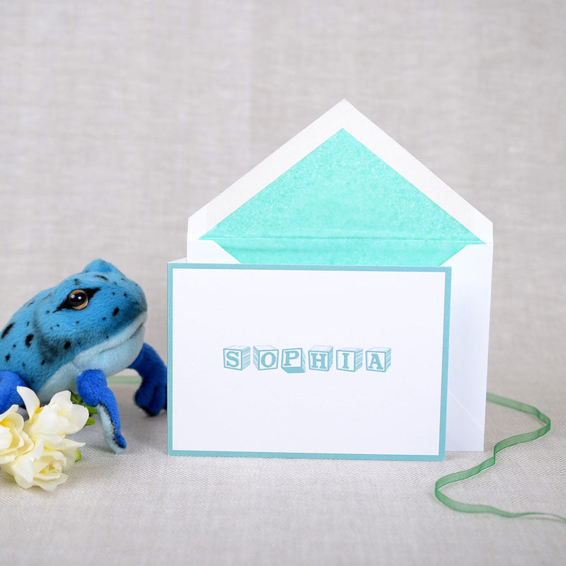 The folded Allendale birth announcement cards and envelope with teal tissue paper lining
