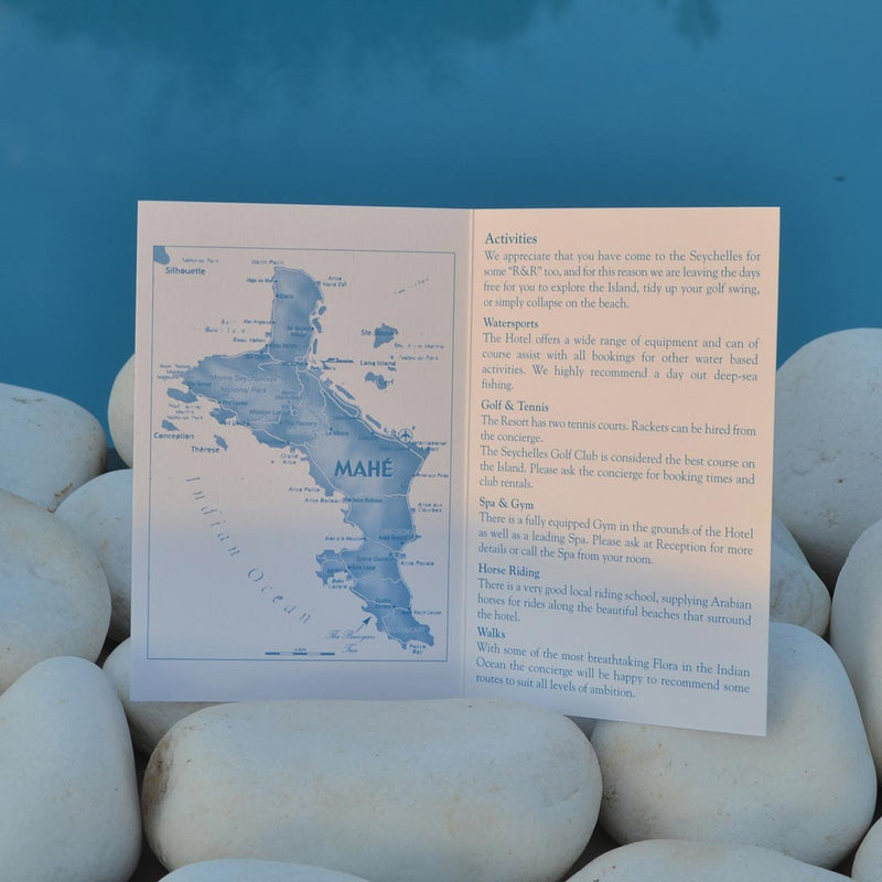 The Avani wedding information cards, printed in tabriz blue onto two sides of a folded white card