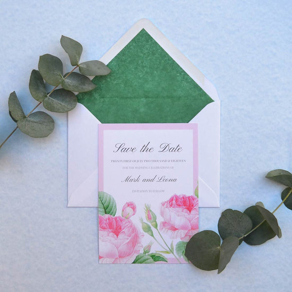 The Bamburgh save the date card designed with holiday green tissue linings for the envelopes