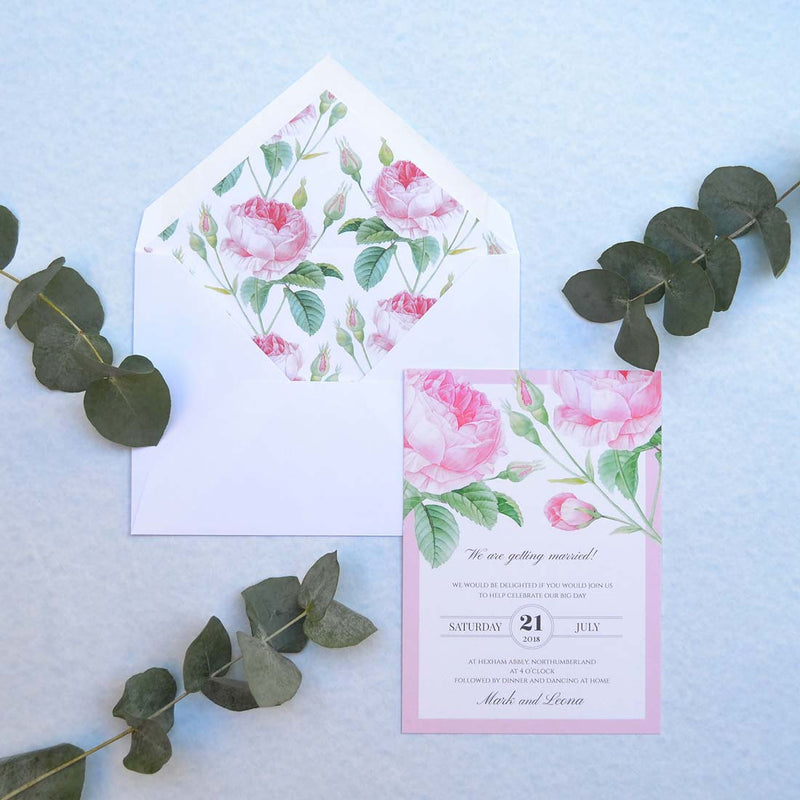 The Bamburgh wedding invitation, resting face up on a matching peony printed lined envelope