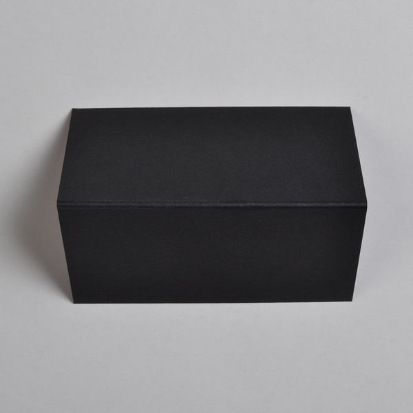 The Black Wedding name place cards shown flat on a table surface with the crease in the middle