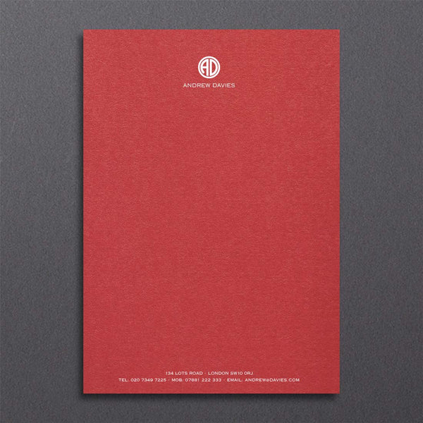 Bronte writing paper displays a contemporary monogram at the head and details at the foot, printed in white ink onto a bright red sheet