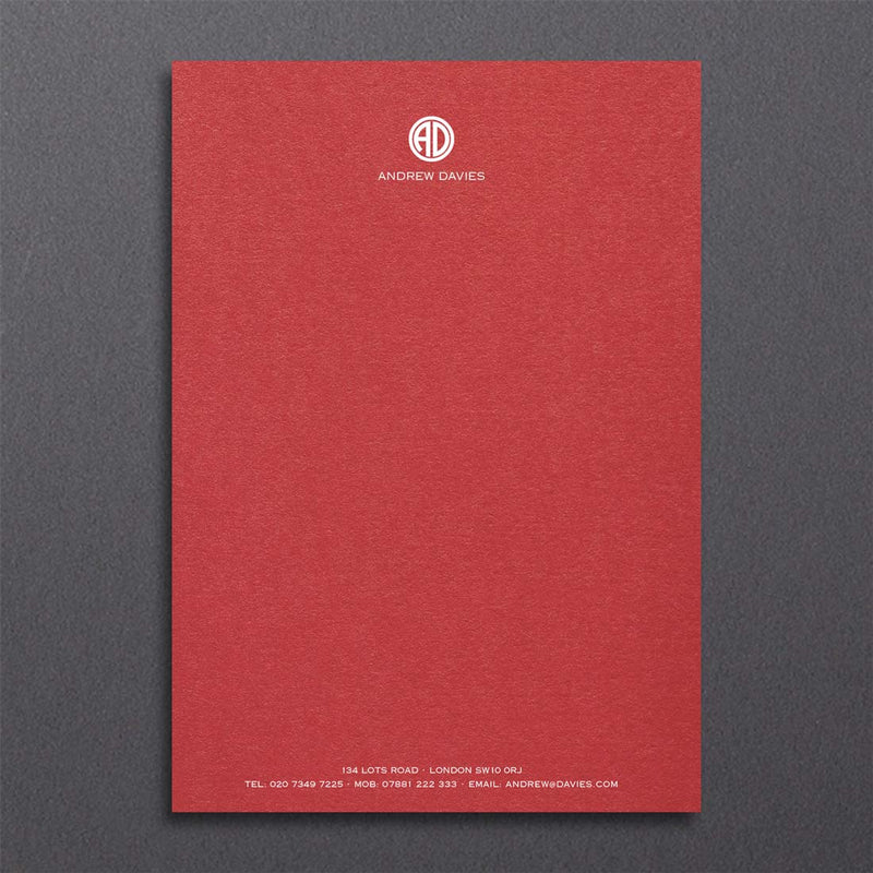 Bronte writing paper displays a contemporary monogram at the head and details at the foot, printed in white ink onto a bright red sheet