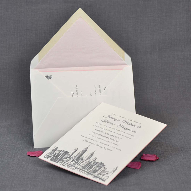 The Brooklyn wedding invitations reclining against thier pink tissue lined envelopes