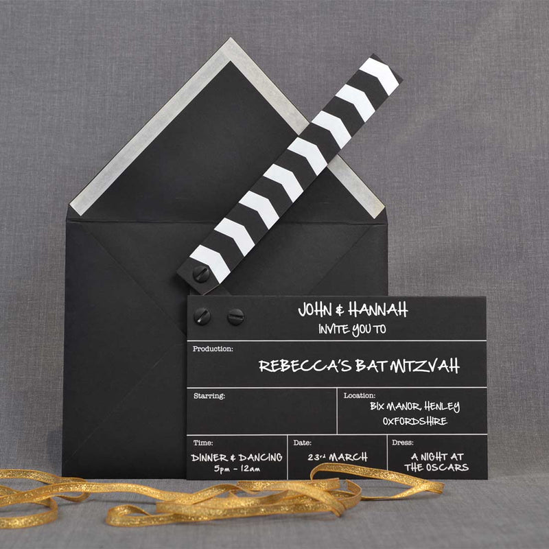 The clapper board party invitations shown with their black envelope and clapper up