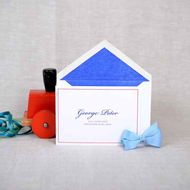 The folded Clifton birth announcement cards and envelope with Midnight blue tissue paper lining