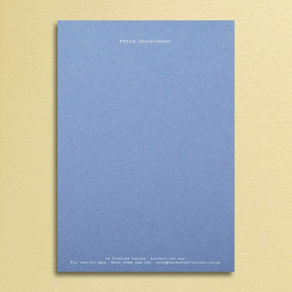 An elegant writing paper design printed in white ink onto a new blue sheet