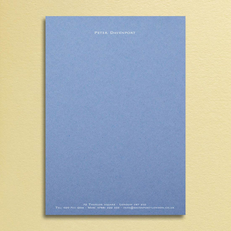 An elegant writing paper design printed in white ink onto a new blue sheet