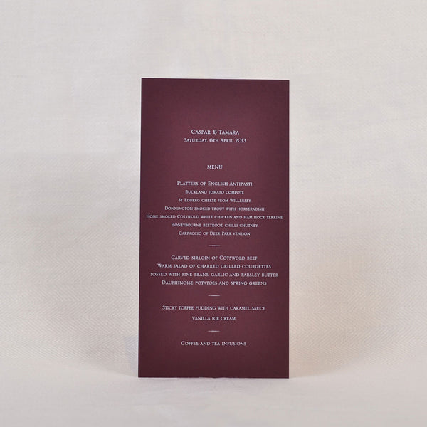 The Cotswold wedding menu shows engraved white ink on a claret coloured card