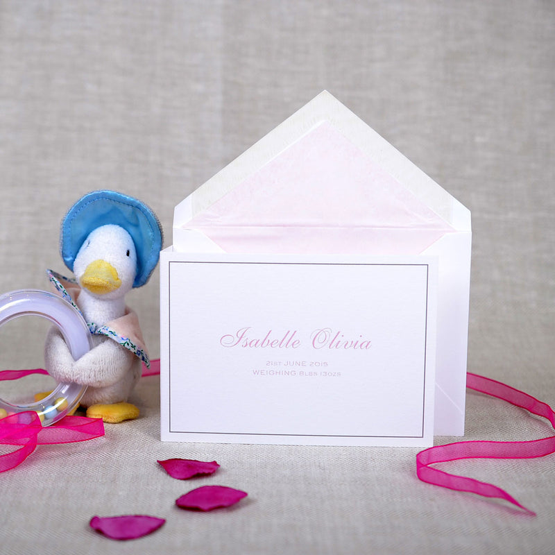 The folded Crawford birth announcement cards and envelope with pale pink tissue paper lining 
