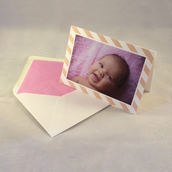 The emma baby photo thank you cards, showing soft coral pink striped borders which complement the colours in the picture