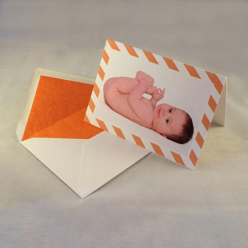 The Ethan baby boy thank you cards, showing bright orange striped borders which complement the tone in the picture