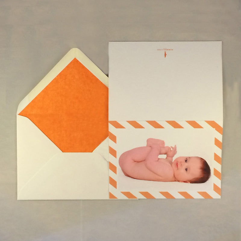 The Ethan luxury baby boy cards with orange tissue paper lined envelope to complement the border colour