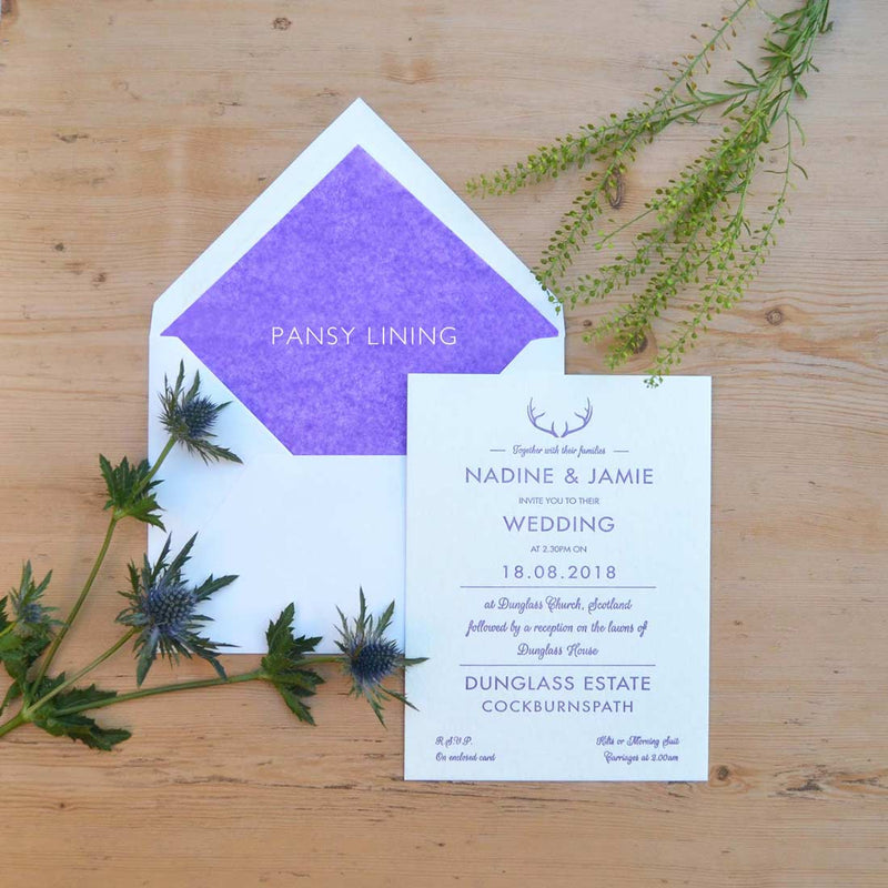 The Glenkeith letterpressed wedding invitations is shown with a pansy tissue paper lined envelope