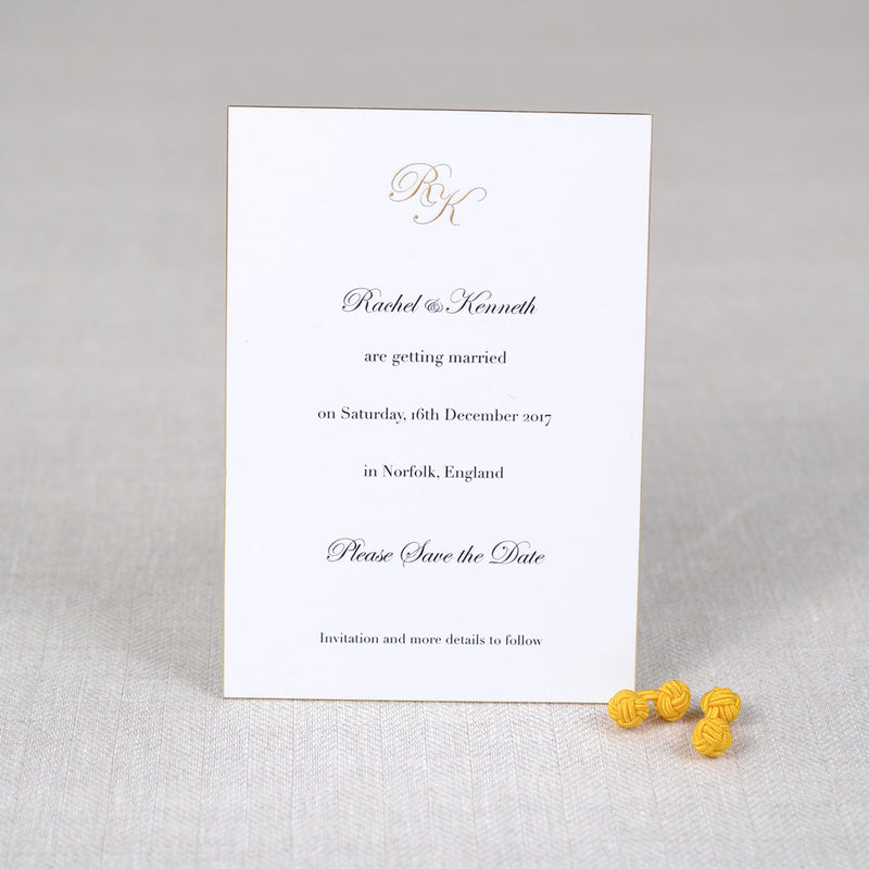 The Holkham wedding save card shows a gold engraved monogram at the head and black text which is raised printed