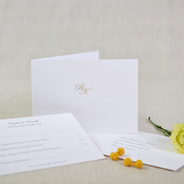 The Holkham Wedding RSVP Card landscape and folded, with your monogram engraved in gold on the front cover
