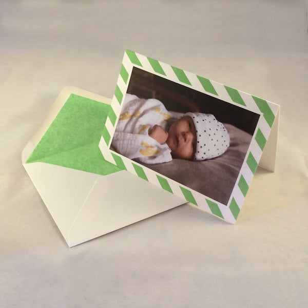 The isabella baby photo thank you cards, showing spring green striped borders which complement the tone in the picture