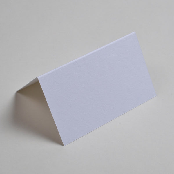 The Ivory or off-white place cards are a tent folded and smooth to the touch