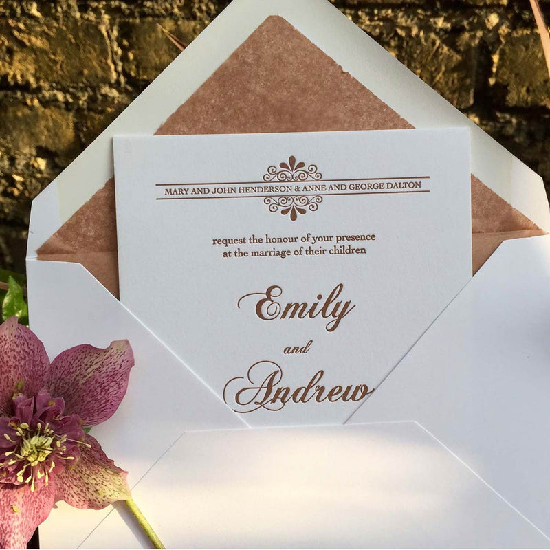 The Kenwood letterpressed wedding invitation protruding from it's matching tissue paper lined envelope
