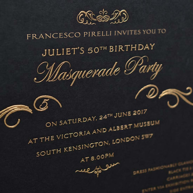 A close up of the gold engraving of the party invitation text