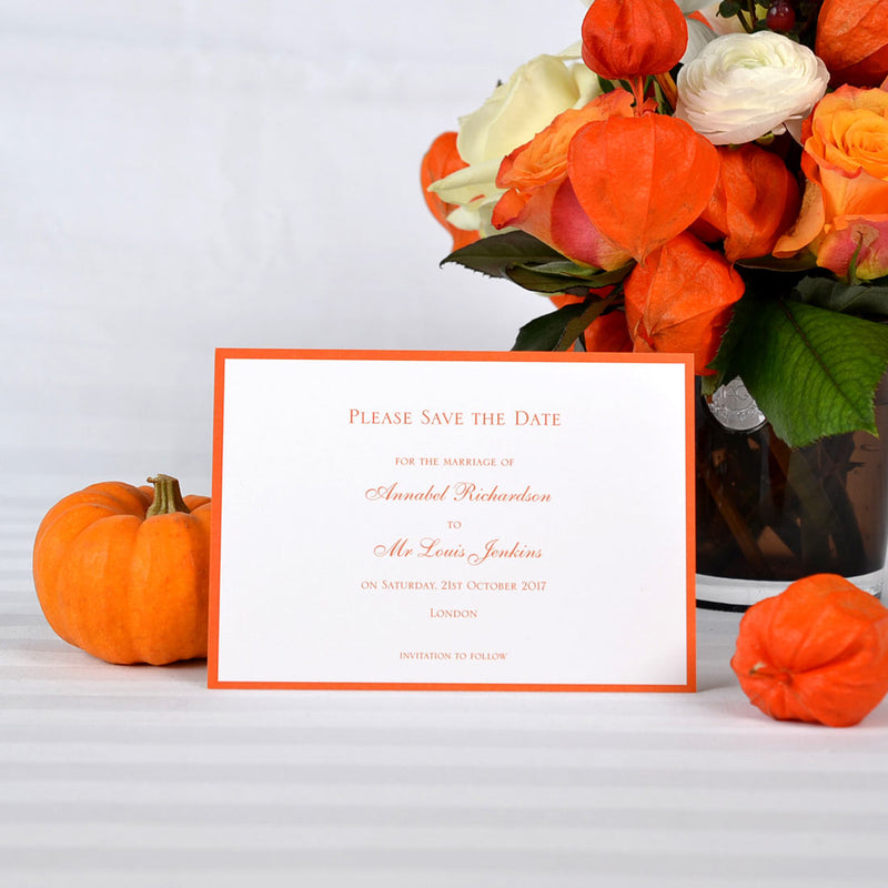 The Mayfair wedding save the date card is flatprinted with orange text and matching border